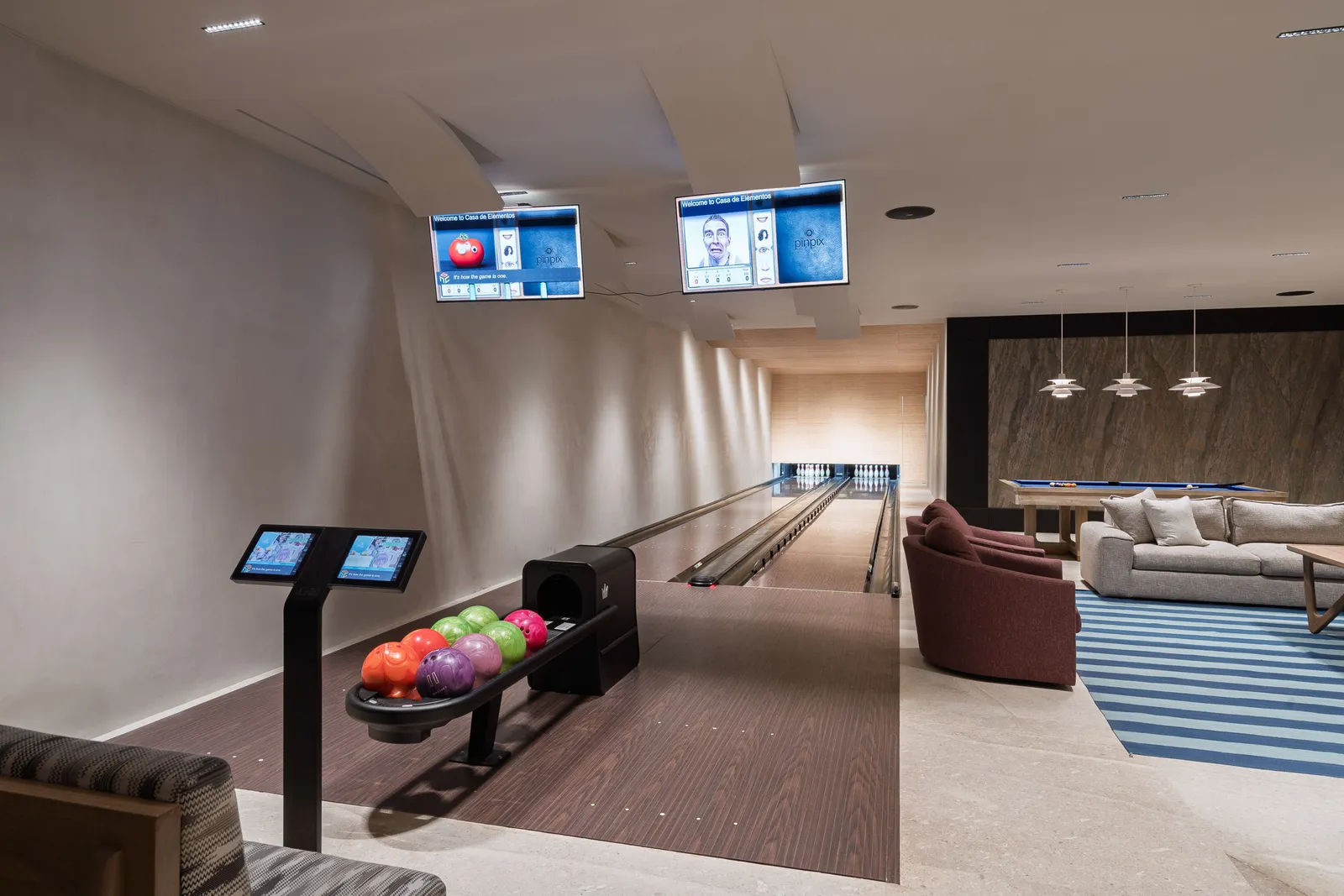 Down the two private bowling lanes, scoreboards lit overhead