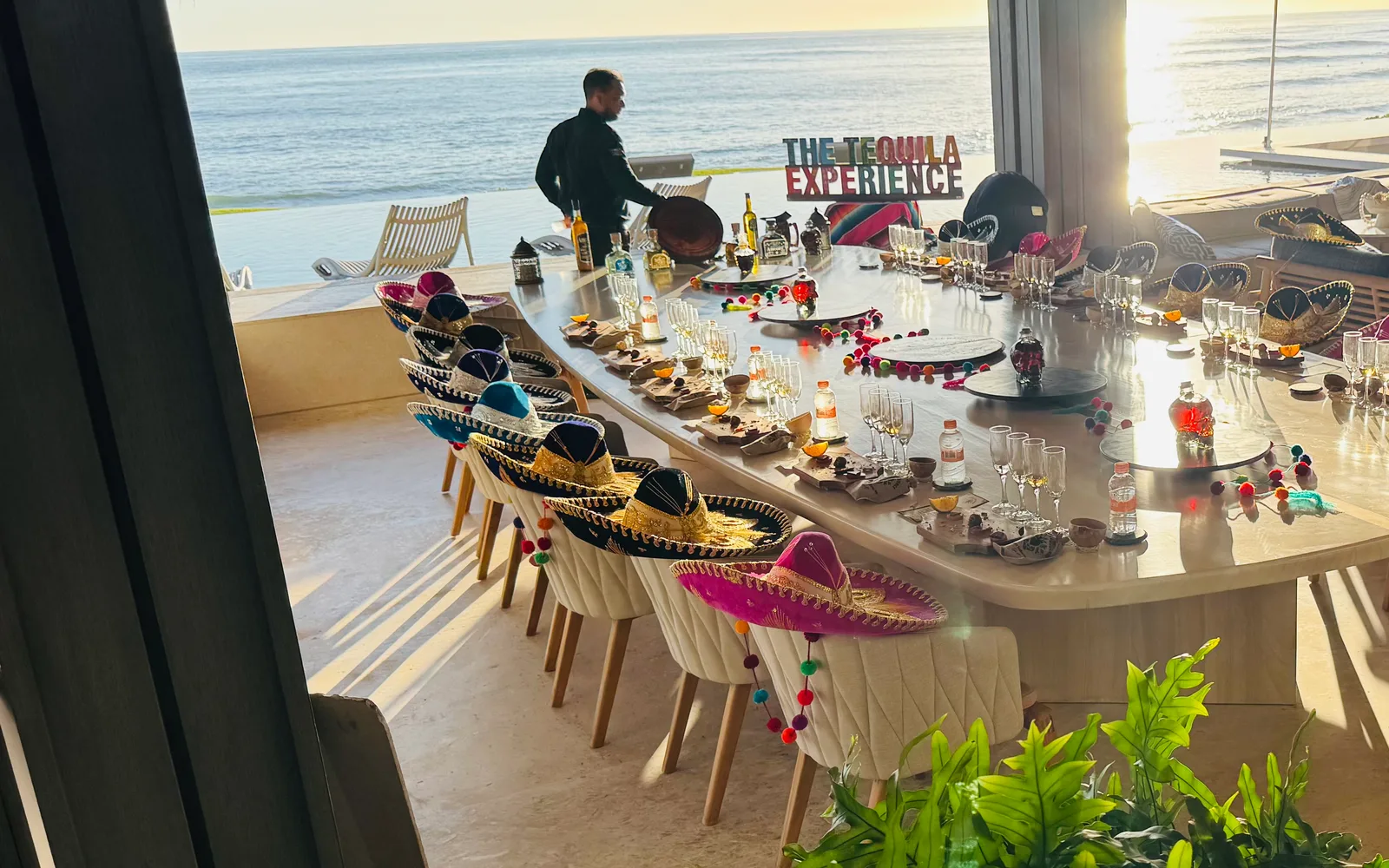 The Tequila Experience — the long table set with sombreros under the palapa, ocean beyond