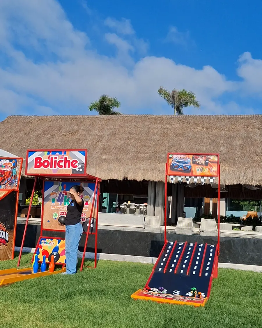 Carnival game booths lined up on the lawn in front of the house