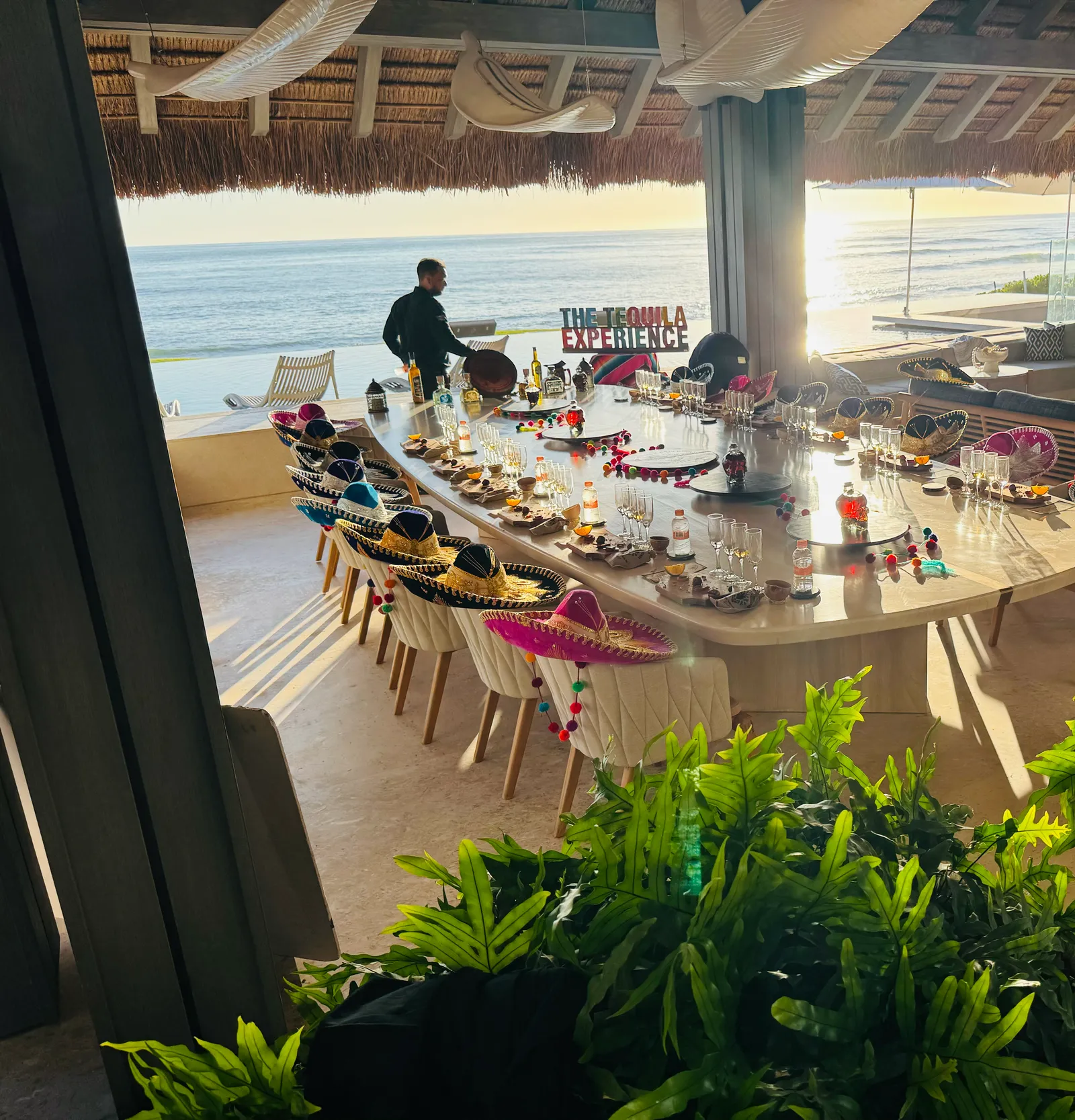 The Tequila Experience table in the last of the sun, set above the infinity pool