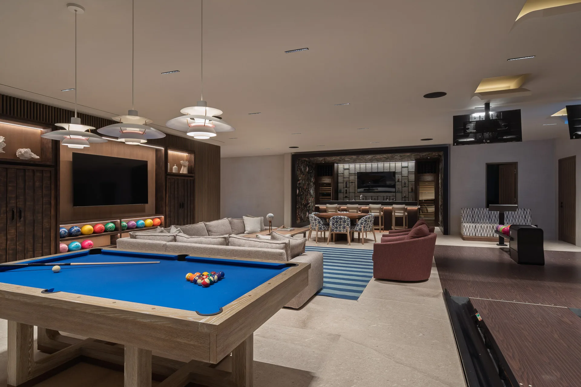 The game room — pool table, poker table and the bar in one room