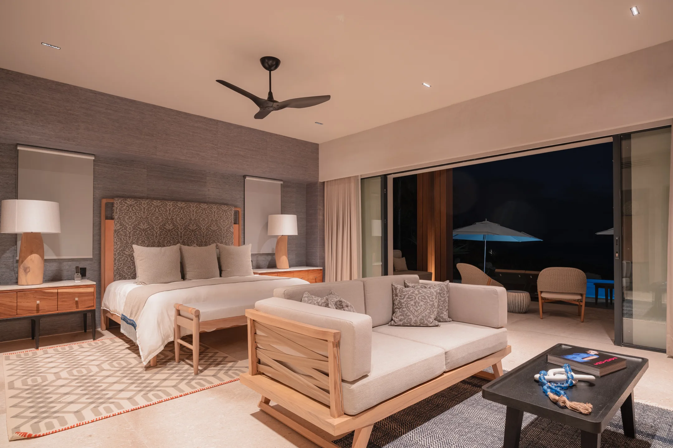 The Ocean Suite at dusk, lamplight on and the terrace glowing