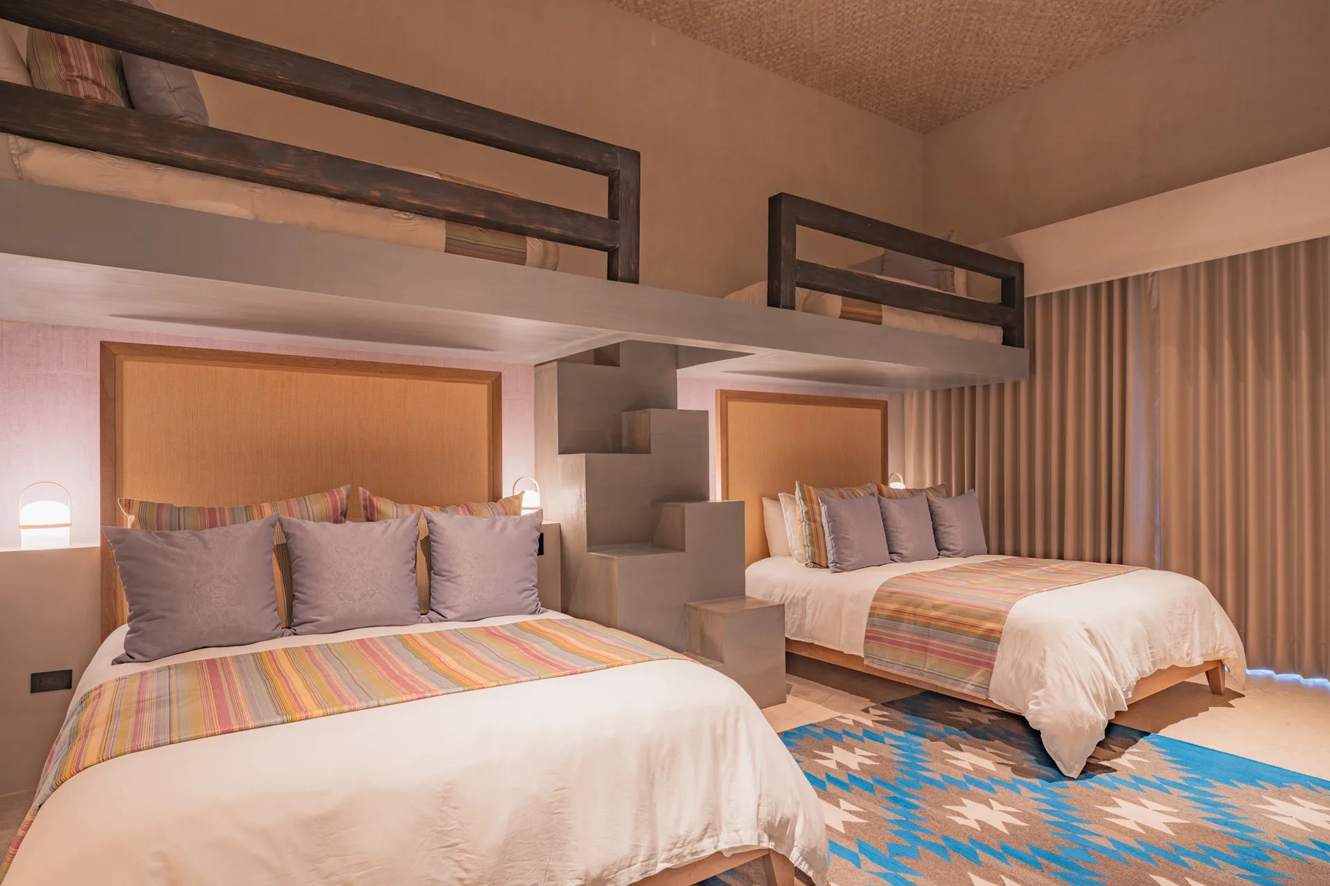 Earth’s family room — two queens and two bunk lofts in warm striped textiles