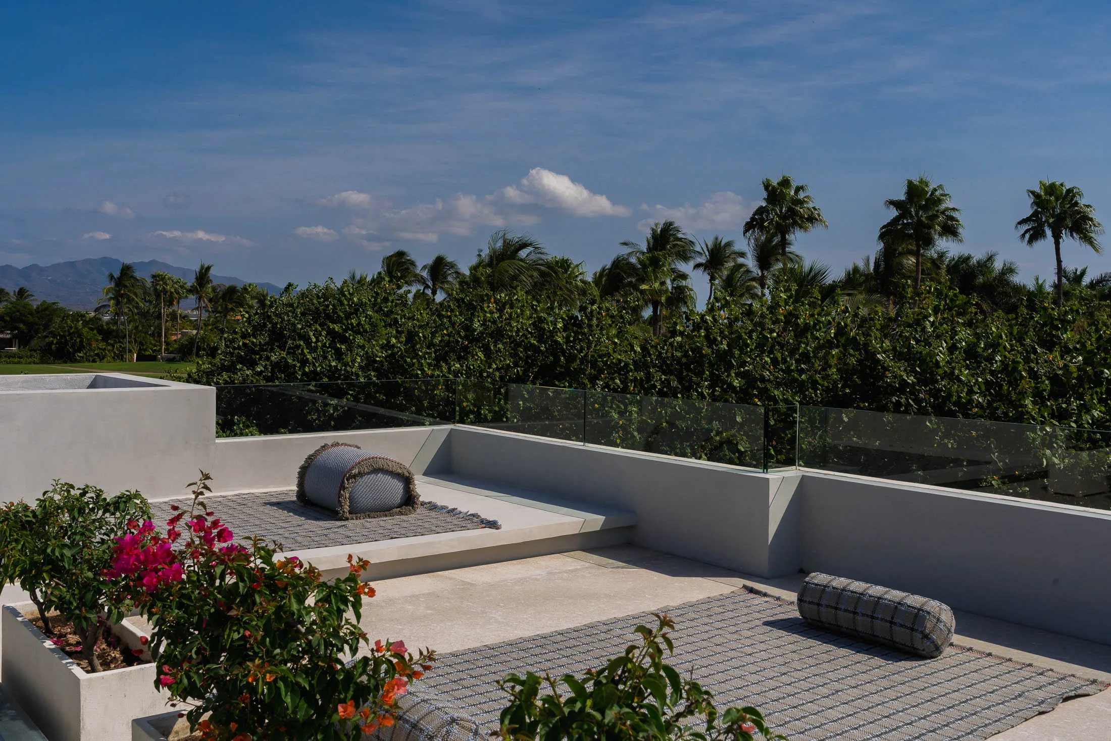 The rooftop yoga deck — mats and bougainvillea in the morning light