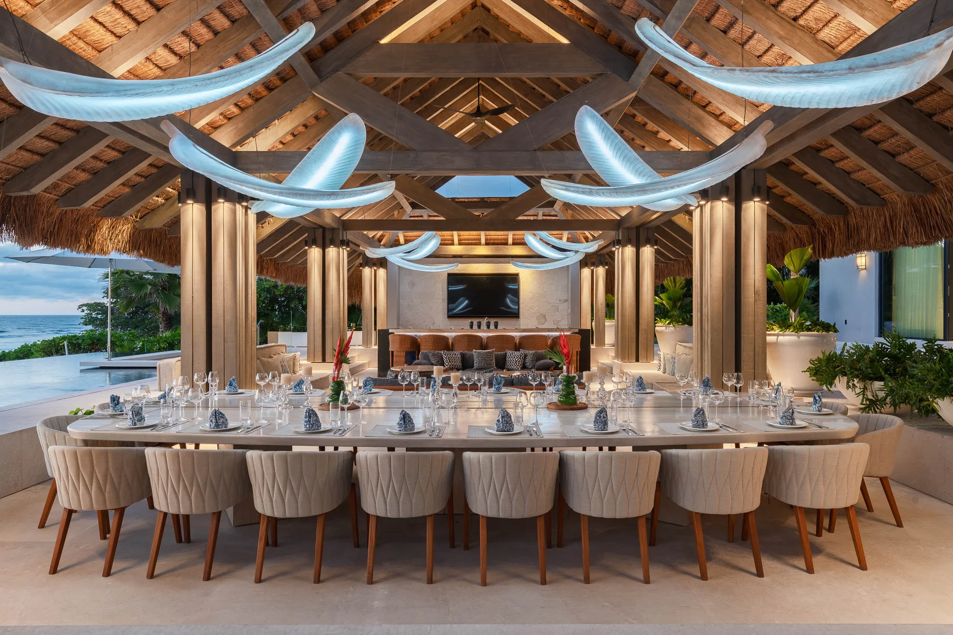 The palapa table at twilight — set for dinner before anyone has asked