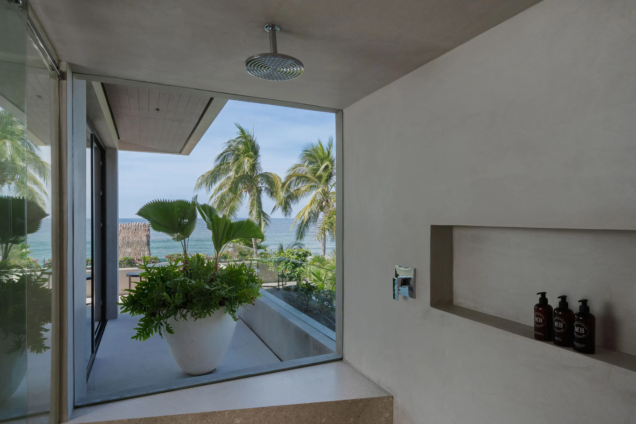 Skye’s private outdoor shower nook — open to the palms and the point below