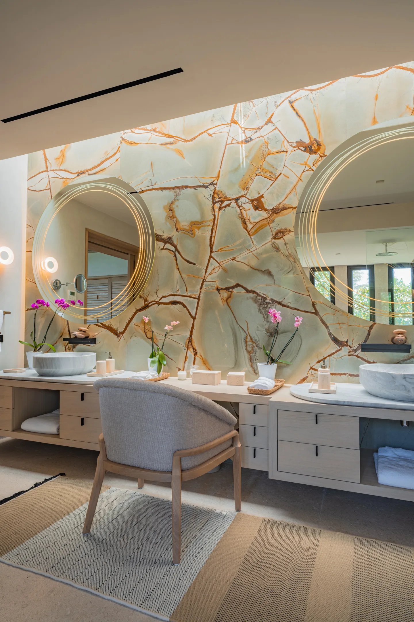 The Star Suite bath — the onyx wall glowing behind the double vanity