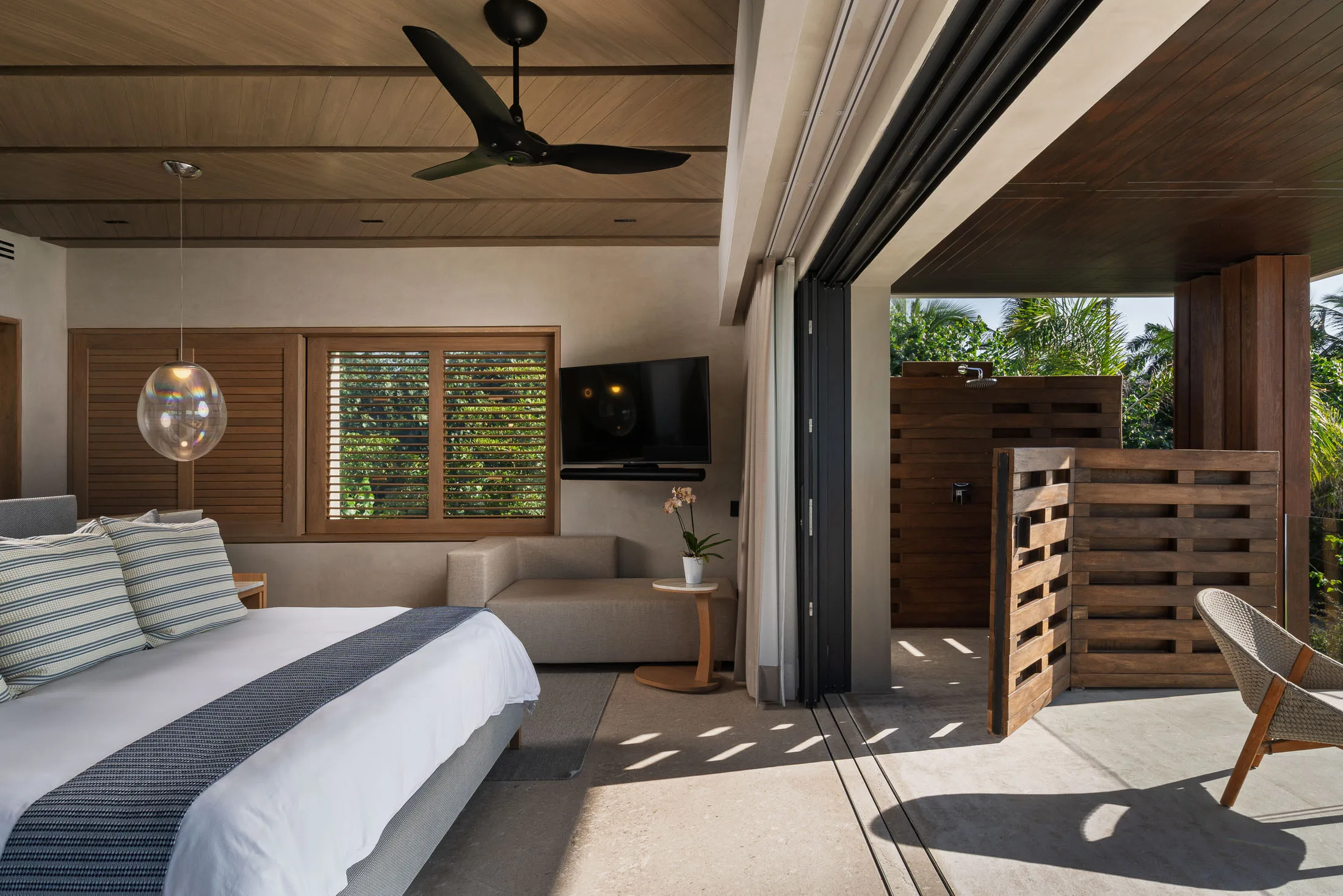 The Star Suite’s sitting corner — sofa by the open glass, the screen beyond
