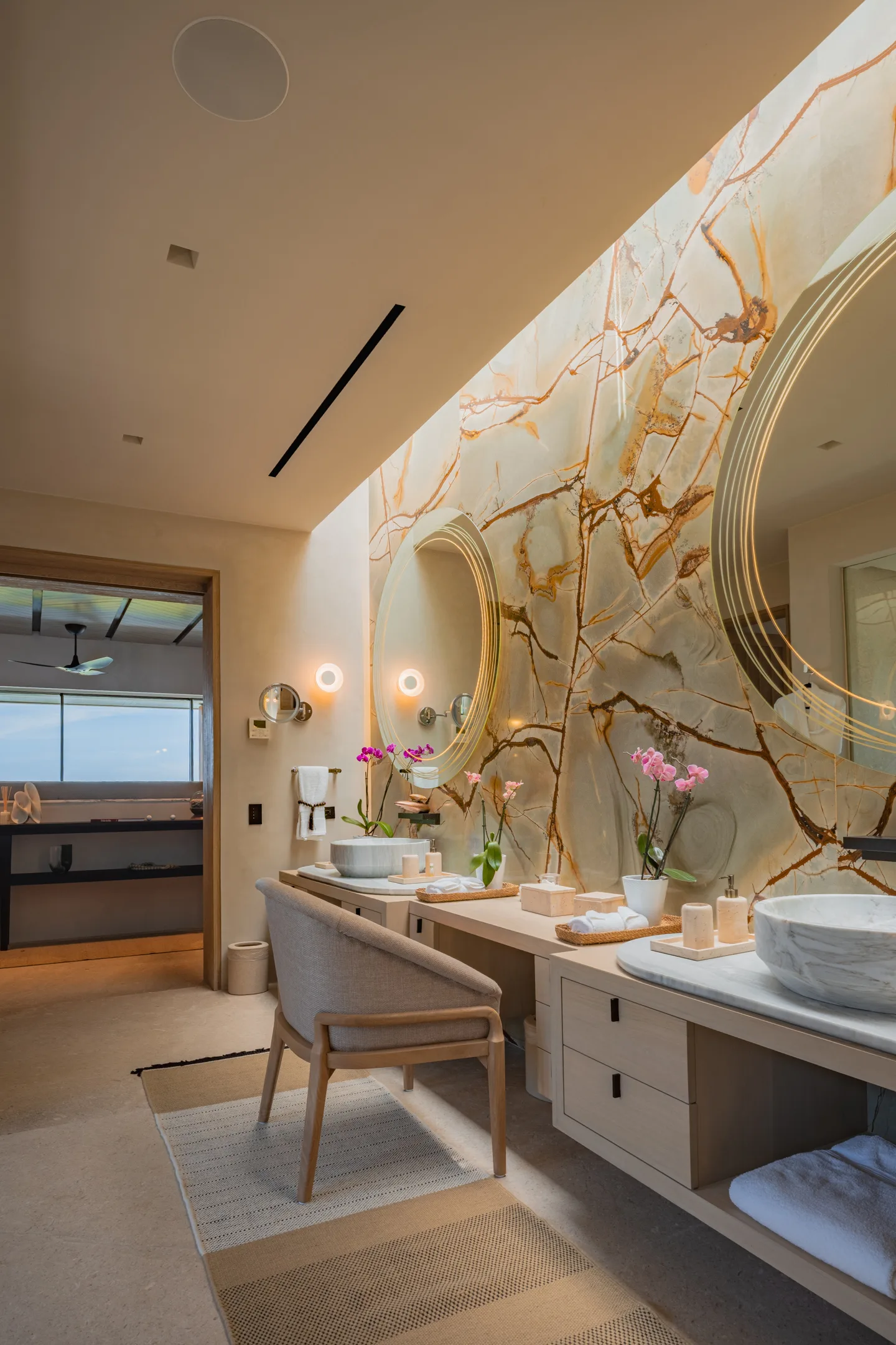 The onyx vanity beside its window, the ocean past the trees