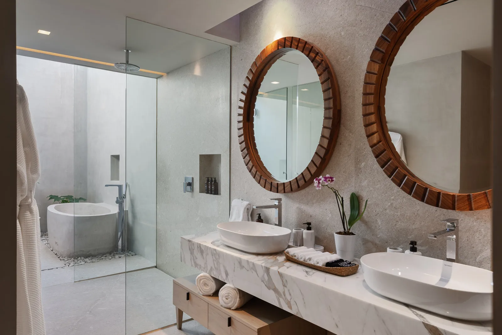The Water Suite bath — full tub beneath the round mirrors